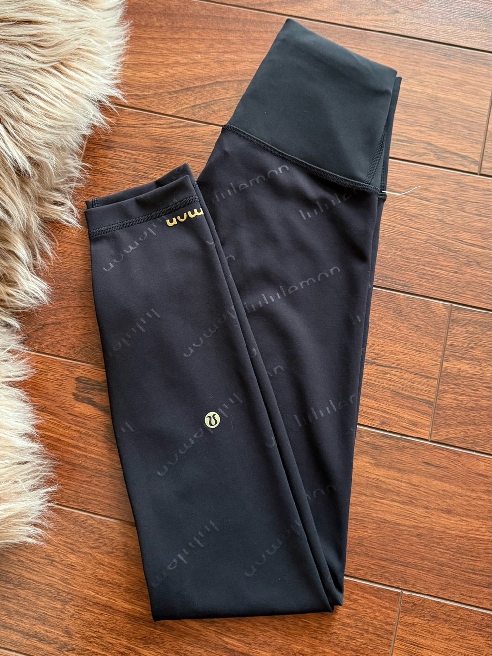 Size 4 Lululemon Wunder train HR 25” graphic black leggings with repeating 'lulu